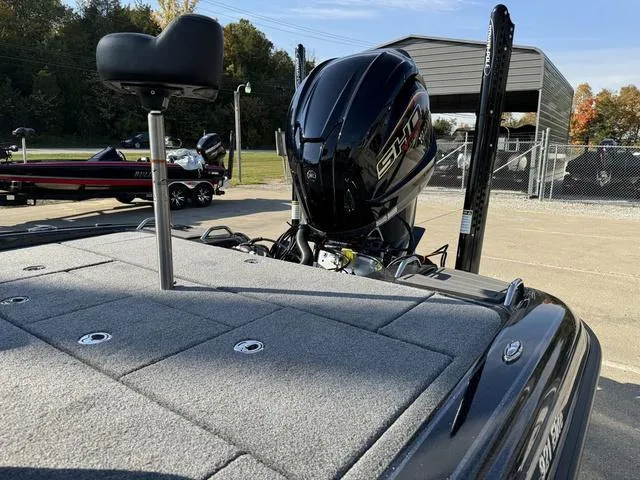 Slide: The Image of 2025 Phoenix 921 ELITE boat with powerful engine, parked outdoors. - 17