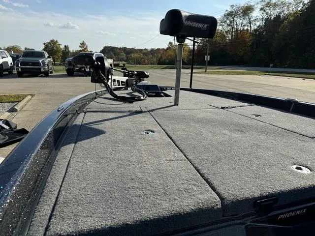 Slide: The Image of 2025 Phoenix 921 ELITE boat deck with trolling motor in parking lot. - 18