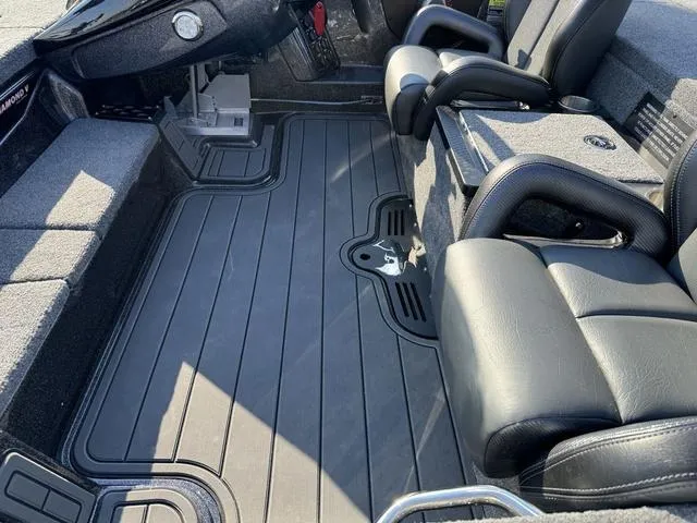 Slide: The Image of 2025 Phoenix 921 ELITE boat interior with black seating and flooring. - 19