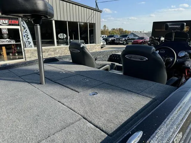 Slide: The Image of 2025 Phoenix 921 ELITE boat interior with gray carpet and dual seats. - 5