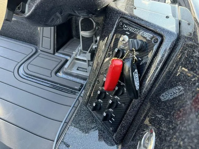 Slide: The Image of Dashboard of 2025 Phoenix 921 ELITE boat with control panel and key fob. - 7