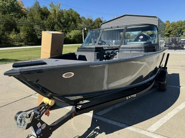 Slide: The Image of 2025 Lund 1775 Adventure Sport boat on trailer, parked outdoors. - 11
