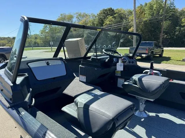 Slide: The Image of 2025 Lund 1775 Adventure Sport boat interior with seating and dashboard. - 14