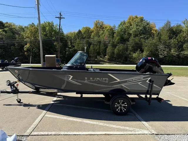 Slide: The Image of 2025 Lund 1775 Adventure Sport boat on trailer in parking lot. - 15