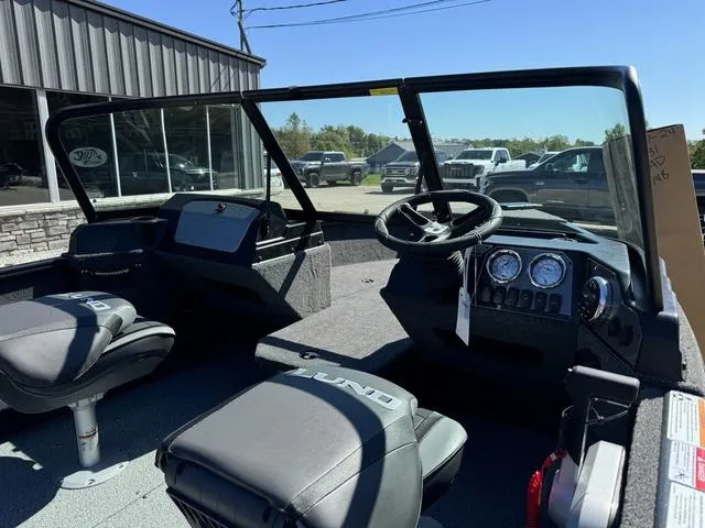 Slide: The Image of 2025 Lund 1775 Adventure Sport boat interior with steering wheel and seating. - 5