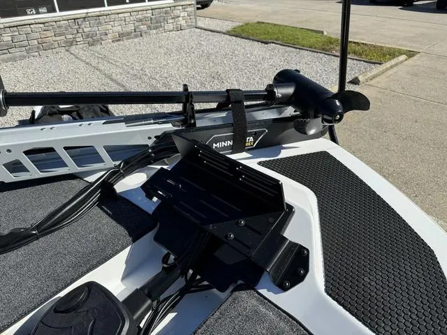 Slide: The Image of iKon VLX 20 boat with Minn Kota trolling motor, 2025 model, on a sunny day. - 10