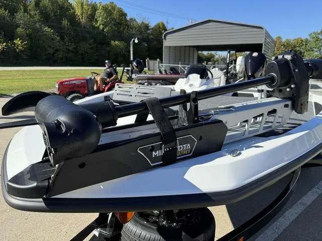 Slide: The Image of 2025 iKon VLX 20 boat with Minn Kota Ultrex trolling motor, parked outdoors. - 13