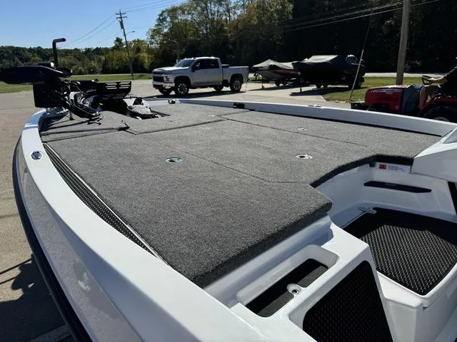 Slide: The Image of 2025 iKon VLX 20 boat deck with fishing equipment, parked outdoors. - 18