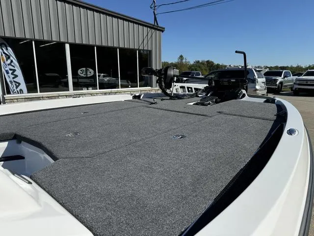 Slide: The Image of iKon VLX 20 boat deck, 2025 model, parked outside dealership. - 8