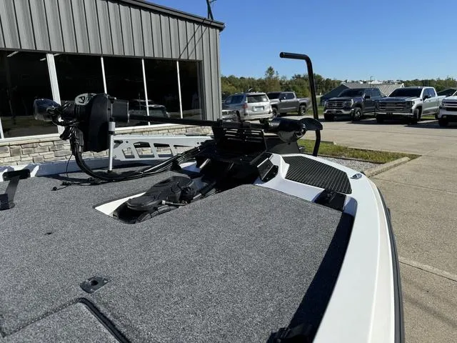 Slide: The Image of iKon VLX 20 boat deck, 2025 model, parked outside dealership with cars in background. - 9