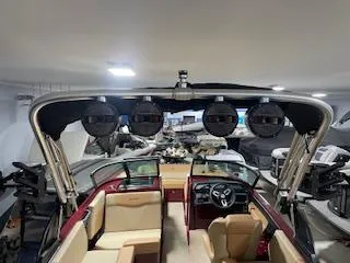 Slide: The Image of 2024 MasterCraft NXT22 boat interior with speakers and seating in showroom. - 3
