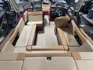 Slide: The Image of 2024 MasterCraft NXT22 boat interior with beige and tan seating, modern design, and spacious layout. - 4