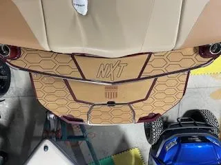 Slide: The Image of 2024 MasterCraft NXT22 boat with hexagonal-patterned deck, viewed from above. - 5