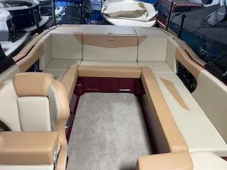 Slide: The Image of 2024 MasterCraft NXT22 boat interior with beige and tan seating. - 6