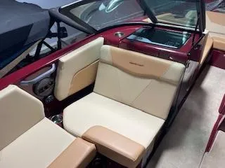 Slide: The Image of 2024 MasterCraft NXT22 boat interior with beige and tan seating, featuring modern design elements. - 7