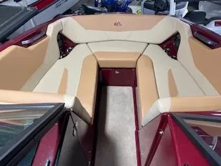 Slide: The Image of 2024 MasterCraft NXT22 boat interior with beige and red seating. - 9
