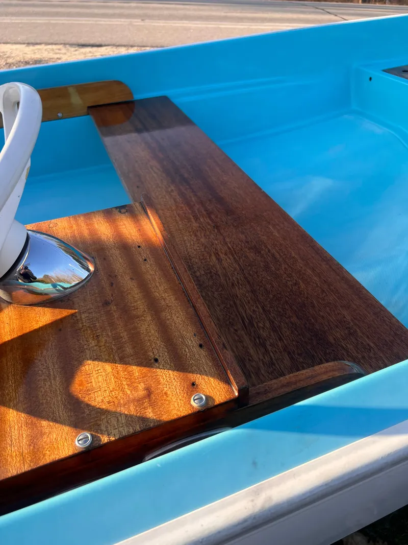 Slide: The Image of 1968 Boston Whaler 13 Sport boat with polished wood interior and blue hull. - 11