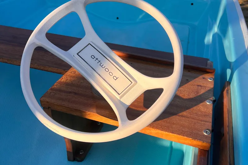 Slide: The Image of 1968 Boston Whaler 13 Sport steering wheel with wooden dashboard detail. - 12