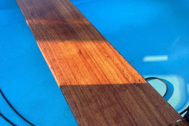 Slide: The Image of Wooden plank on a 1968 Boston Whaler 13 Sport boat, set against a blue background. - 13
