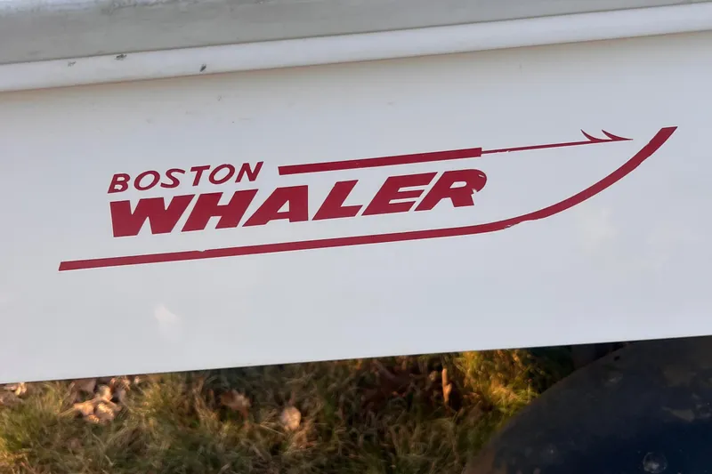 Slide: The Image of 1968 Boston Whaler 13 Sport logo on boat hull. - 14