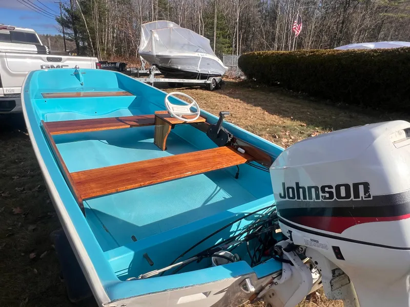 Slide: The Image of 1968 Boston Whaler 13 Sport boat with Johnson outboard motor, parked outdoors. - 19