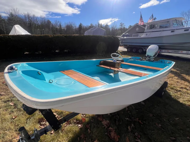 Slide: The Image of 1968 Boston Whaler 13 Sport boat on trailer, sunny outdoor setting. - 20