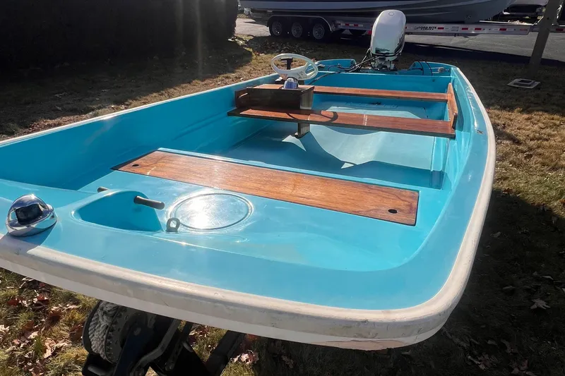 Slide: The Image of 1968 Boston Whaler 13 Sport boat with blue interior and wooden accents. - 21