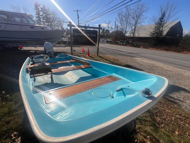 Slide: The Image of 1968 Boston Whaler 13 Sport boat with blue interior, parked outdoors. - 5