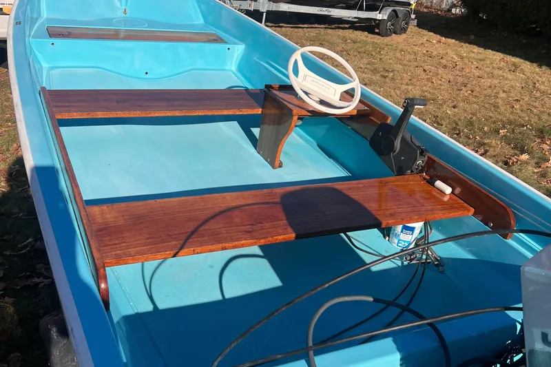 Slide: The Image of 1968 Boston Whaler 13 Sport boat with blue interior and wooden seats. - 9