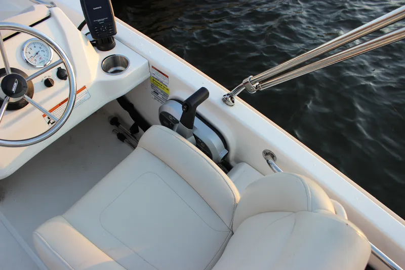 Slide: The Image of 2021 Boston Whaler 130 Super Sport boat interior with steering wheel and seat. - 10