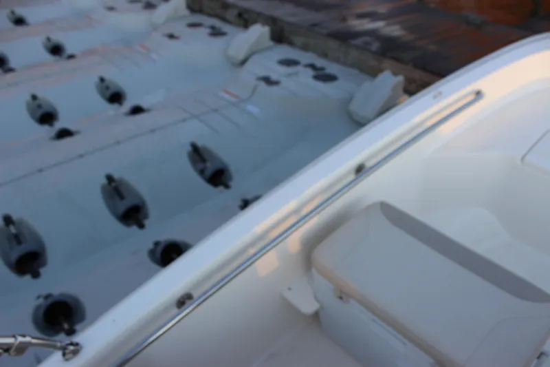 Slide: The Image of 2021 Boston Whaler 130 Super Sport boat detail near dock. - 15