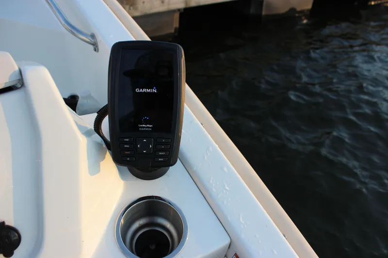 Slide: The Image of 2021 Boston Whaler 130 Super Sport boat dashboard with steering wheel and controls. - 9