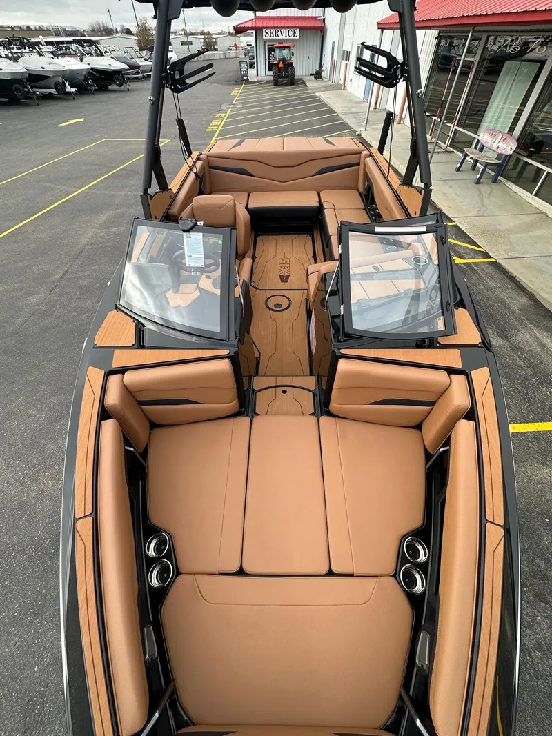 Slide: The Image of 2025 Axis Wake Research T220 boat interior with tan seating and sleek design. - 13