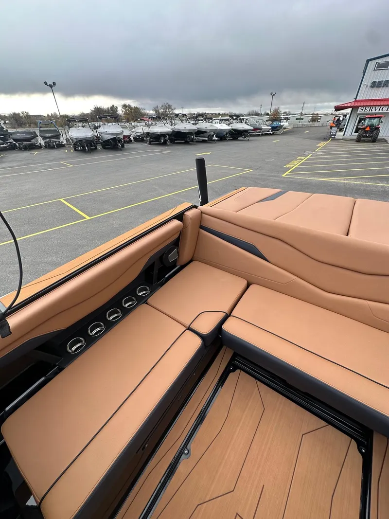 Slide: The Image of 2025 Axis Wake Research T220 boat interior with tan seating and modern design. - 14
