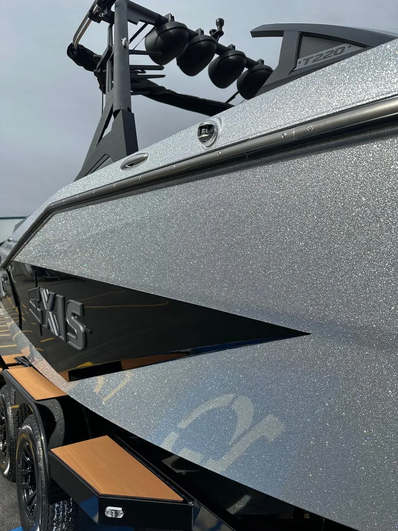 Slide: The Image of 2025 Axis Wake Research T220 boat with sleek metallic finish and modern design. - 3