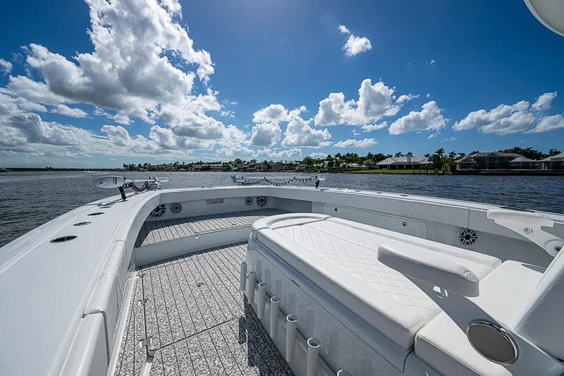 Slide: The Image of Freeman 47T 2023 boat deck with seating, under a bright blue sky. - 10