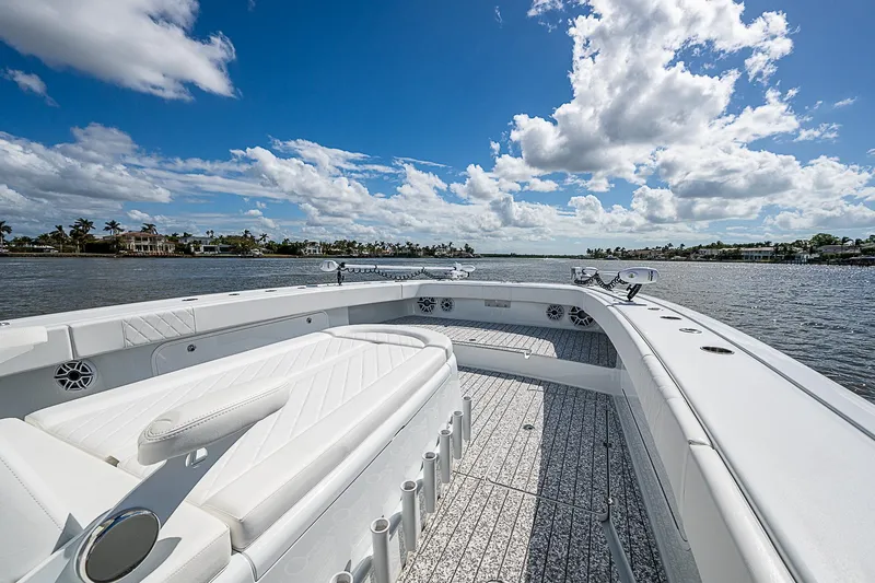 Slide: The Image of 2023 Freeman 47T boat on a sunny day, featuring spacious deck and luxurious seating. - 13