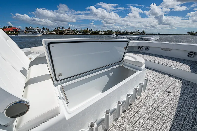 Slide: The Image of Freeman 47T boat deck with open storage compartment, 2023 model, under a clear blue sky. - 15