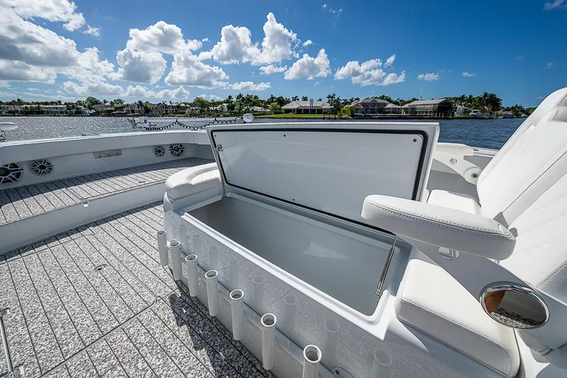 Slide: The Image of 2023 Freeman 47T boat deck with open storage compartment under clear blue sky. - 16
