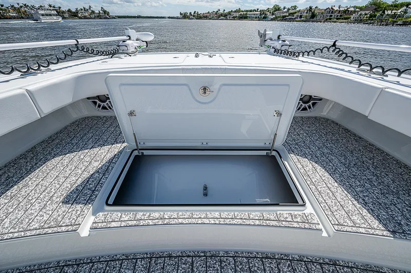 Slide: The Image of Freeman 47T 2023 boat with open storage compartment on deck, overlooking water. - 22