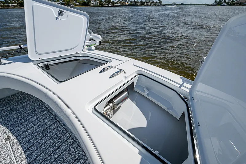 Slide: The Image of Freeman 47T boat deck with open storage compartments, 2023 model, on a calm river. - 25