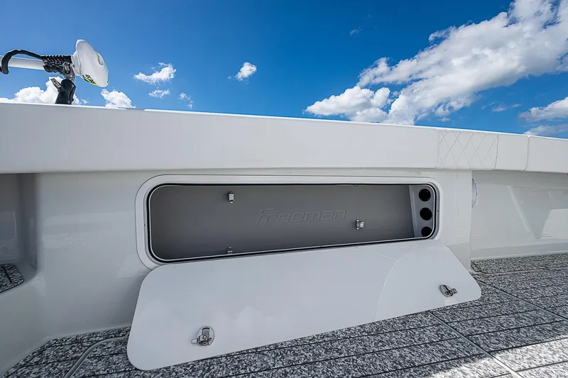 Slide: The Image of Freeman 47T 2023 boat storage compartment under clear blue sky. - 26