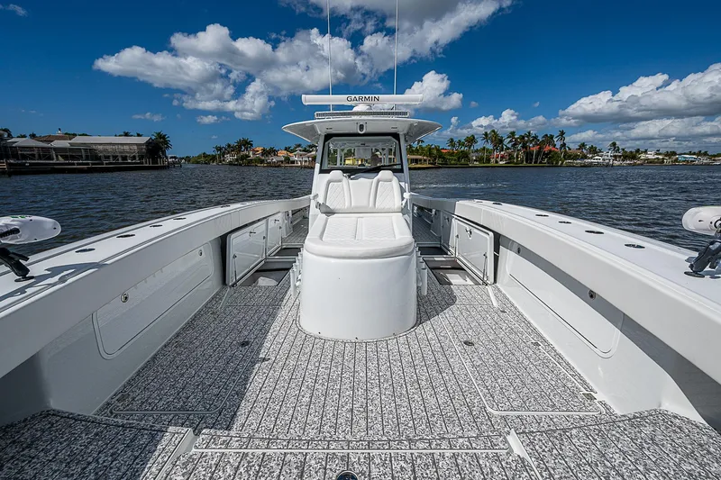 Slide: The Image of Freeman 47T boat, 2023 model, on water with clear sky and shoreline view. - 32