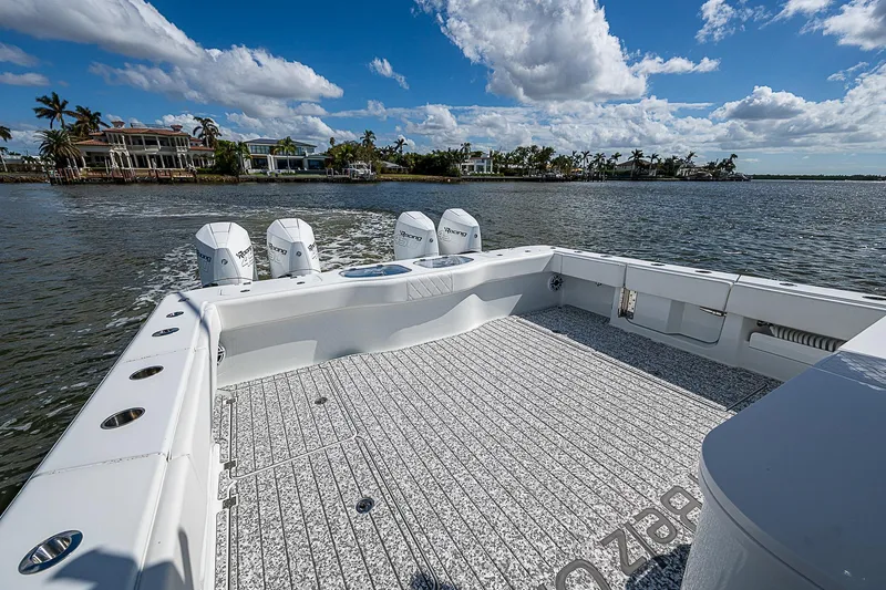 Slide: The Image of 2023 Freeman 47T boat on water, spacious deck, clear sky, coastal view. - 33