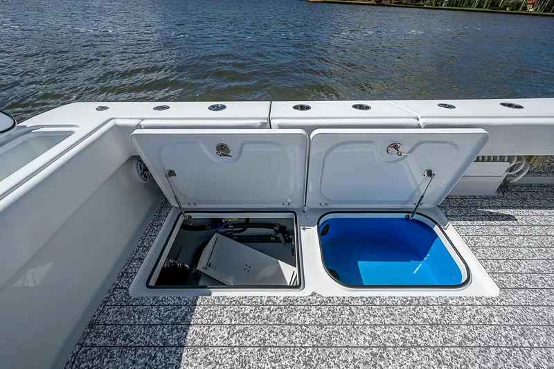 Slide: The Image of Freeman 47T 2023 boat deck with open storage compartments by the water. - 38