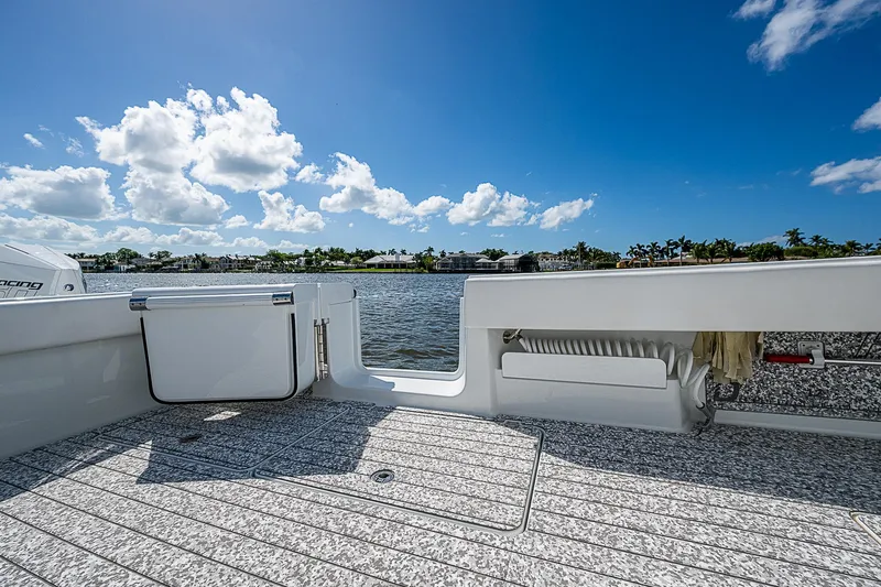 Slide: The Image of Freeman 47T boat deck, 2023 model, with scenic water view and blue sky. - 40