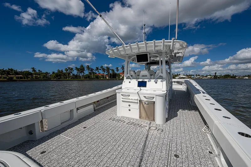Slide: The Image of Freeman 47T boat on water, 2023 model, clear sky, palm trees in background. - 46