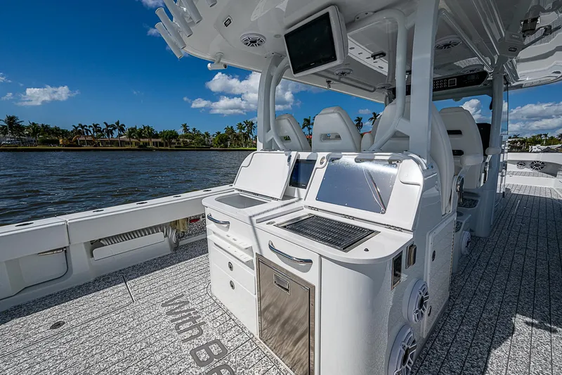 Slide: The Image of Freeman 47T 2023 boat interior with advanced navigation systems and seating, on a sunny day. - 47