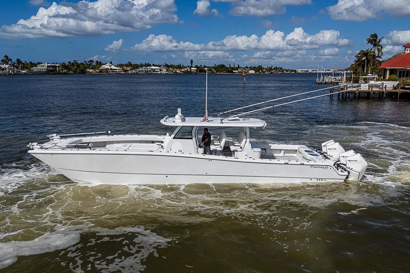 Slide: The Image of Freeman 47T 2023 boat cruising on a sunny day in a scenic waterway. - 6