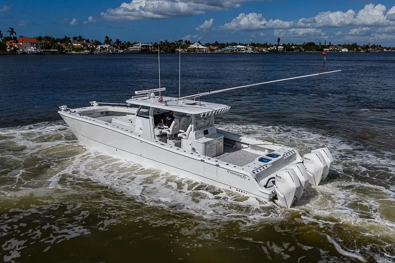 Slide: The Image of 2023 Freeman 47T boat cruising on a sunny day in calm waters. - 8
